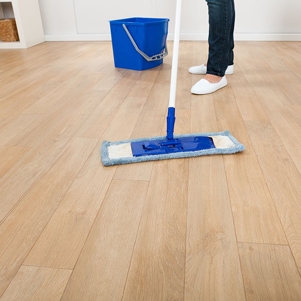 Woman Mopping Hardwood Floor At Home | Premiere Home Center