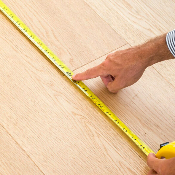 Man measuring floor | Premiere Home Center
